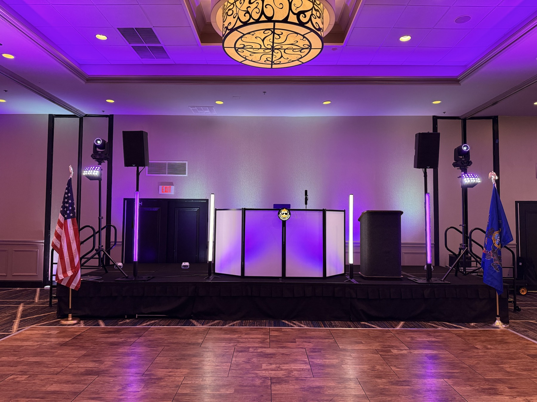 A polished stage, DJ and lighting setup for a formal organization event