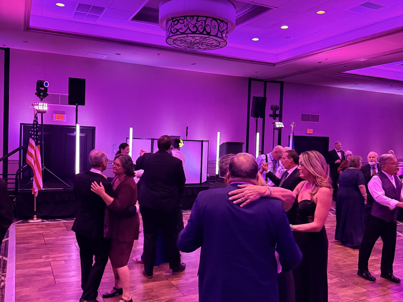 Guests dancing close to the DJ booth at a private celebration