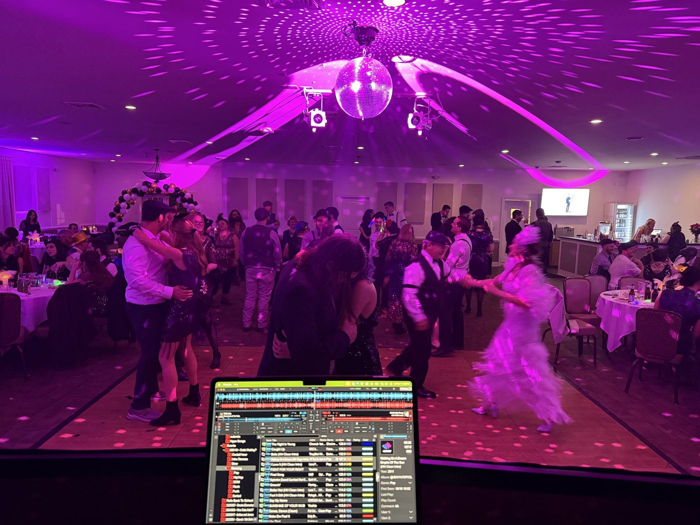 A wide view of a private party with professional sound and lighting
